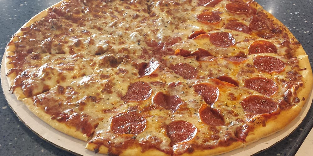 A pepperoni pizza is shown on the table.