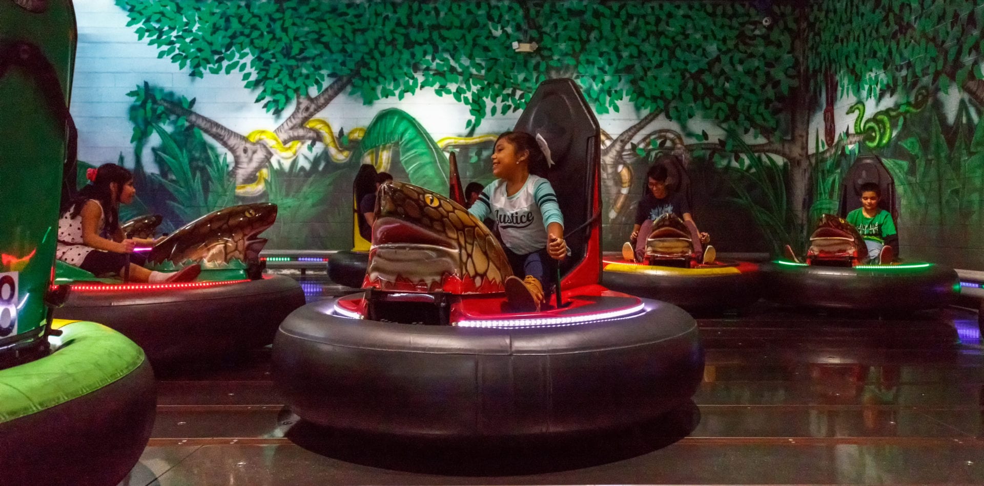 A child rides in an inflatable bumper car.