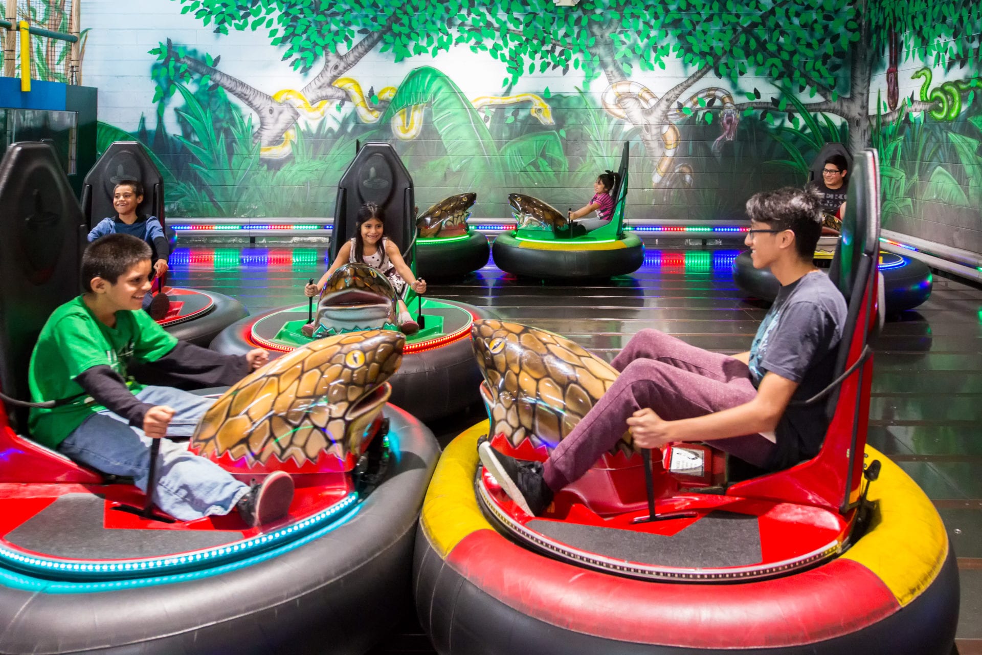 A man and woman are riding on bumper boats.