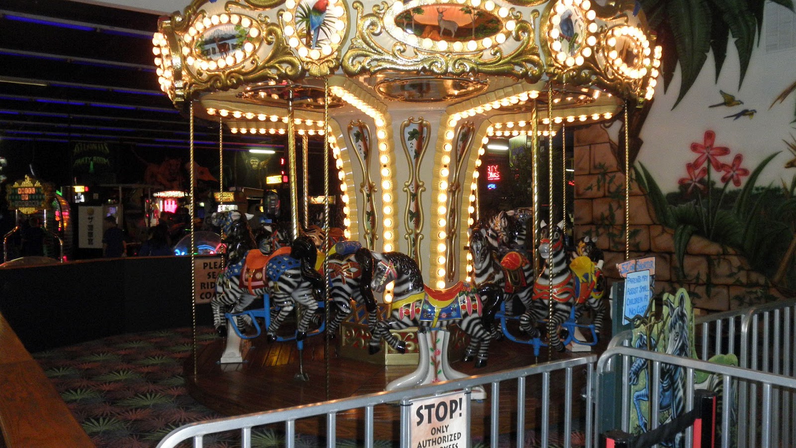 A carousel with people riding it at night.