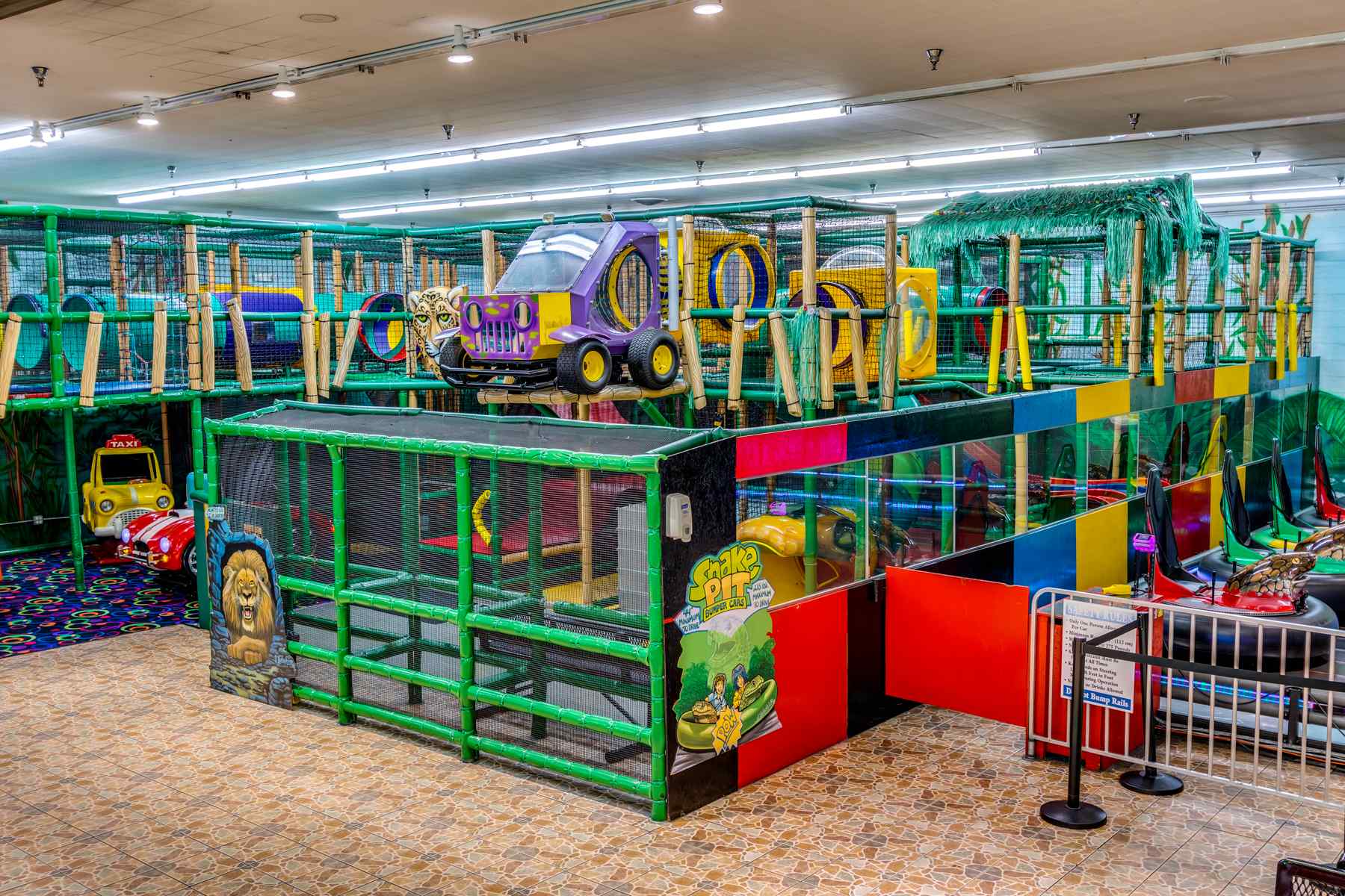 A large indoor playground with cars and other toys.