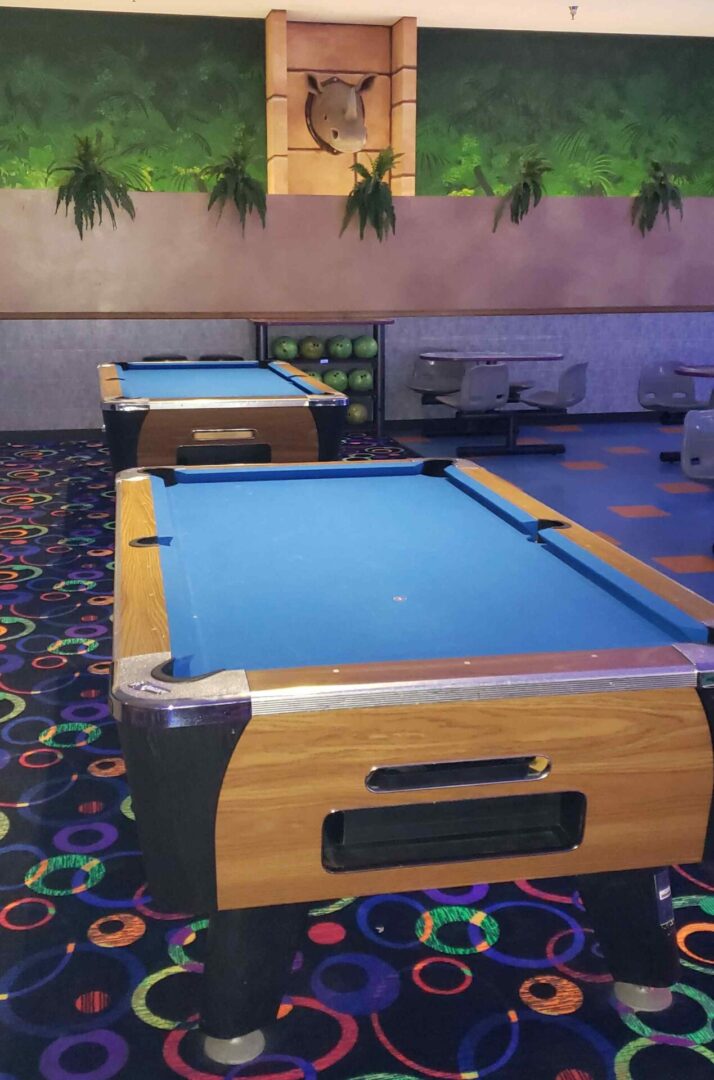 A pool table with two blue balls on it.