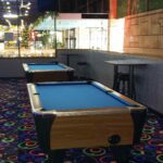 A pool table in the middle of a room.